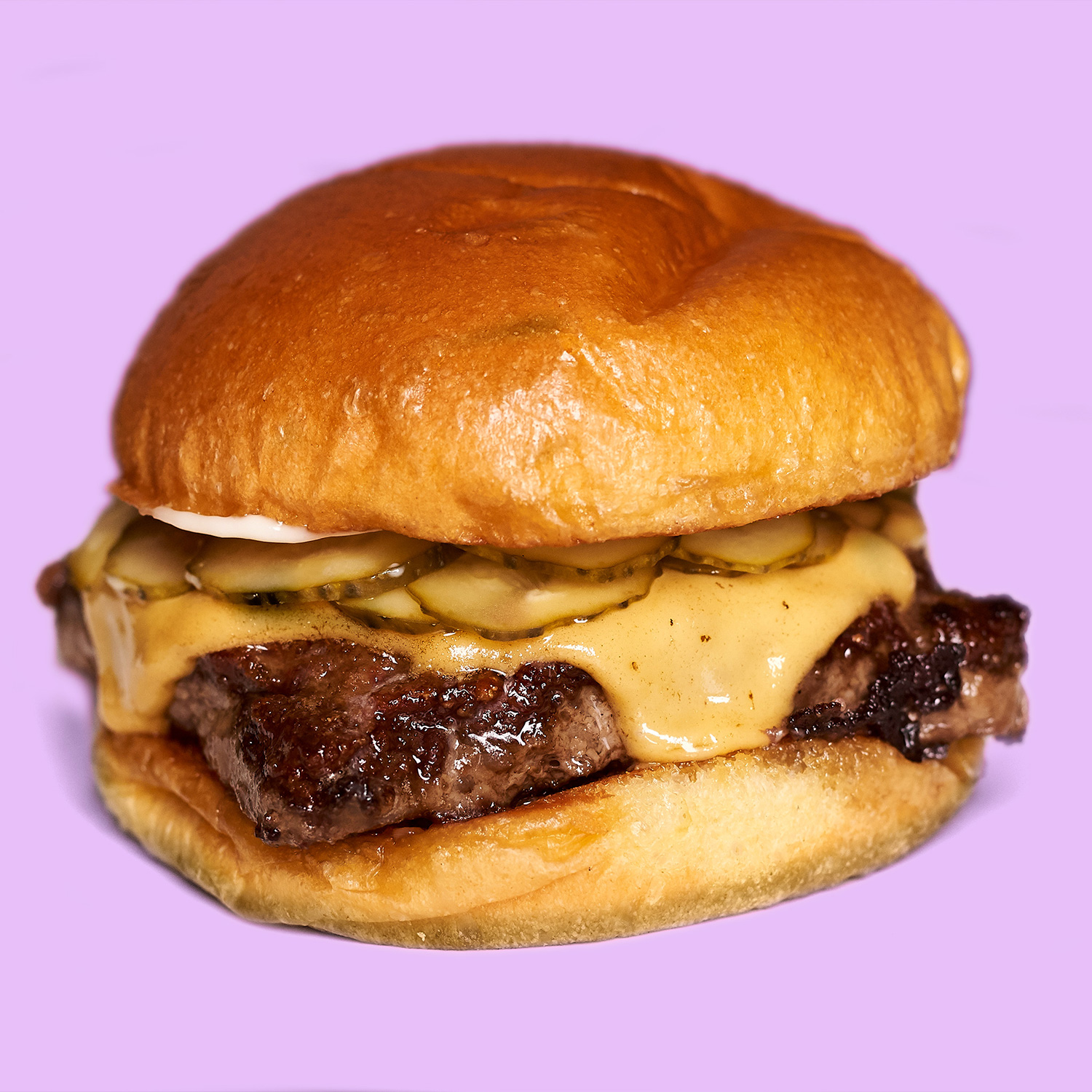 A Richard Eaglespoon burger with a purple background and a square burger patty. With the right technology, any patty shape is possible.