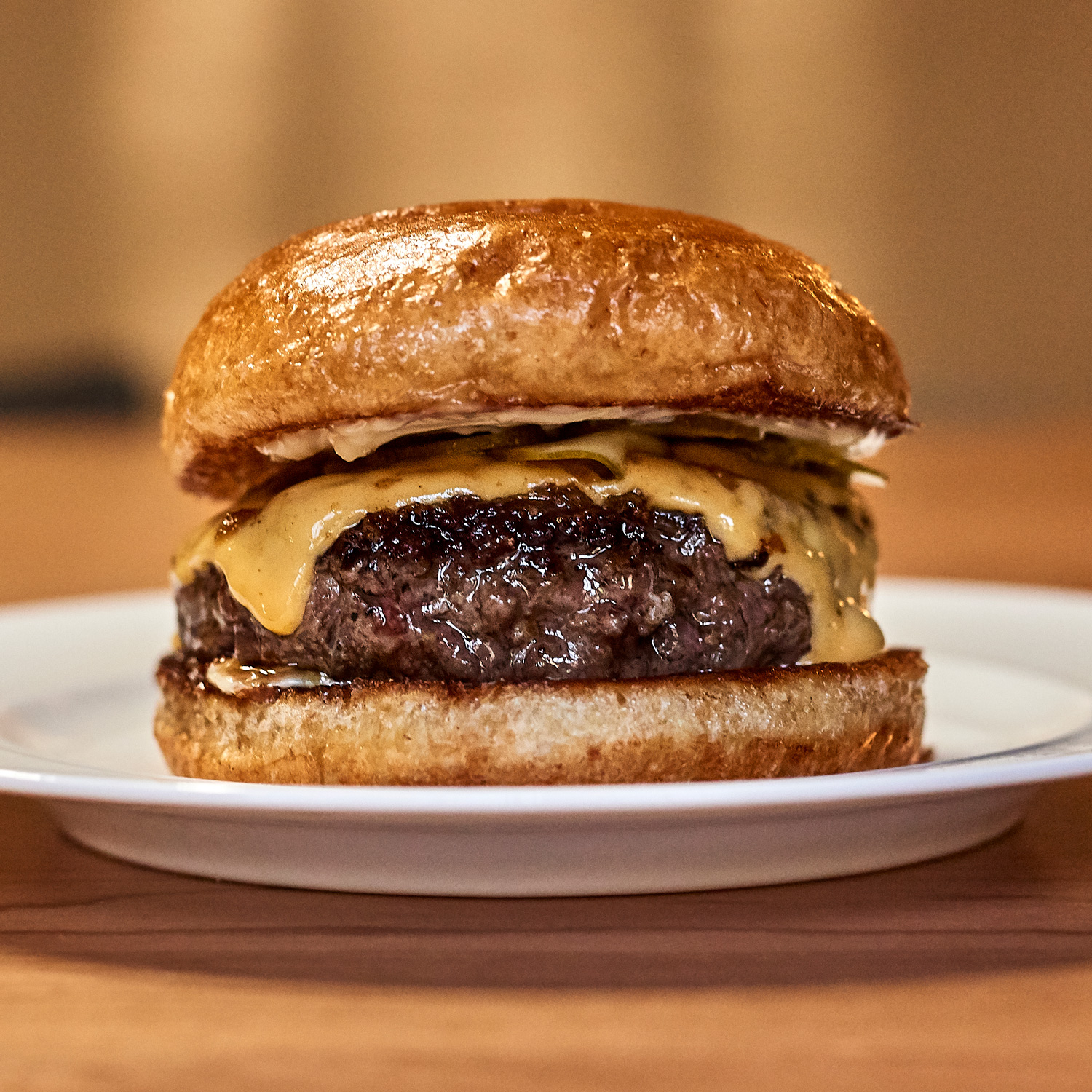 A Richard Eaglespoon burger on a plate. I accidentally bought a whole wheat brioche bun for this burger. Do not follow me down that hole.