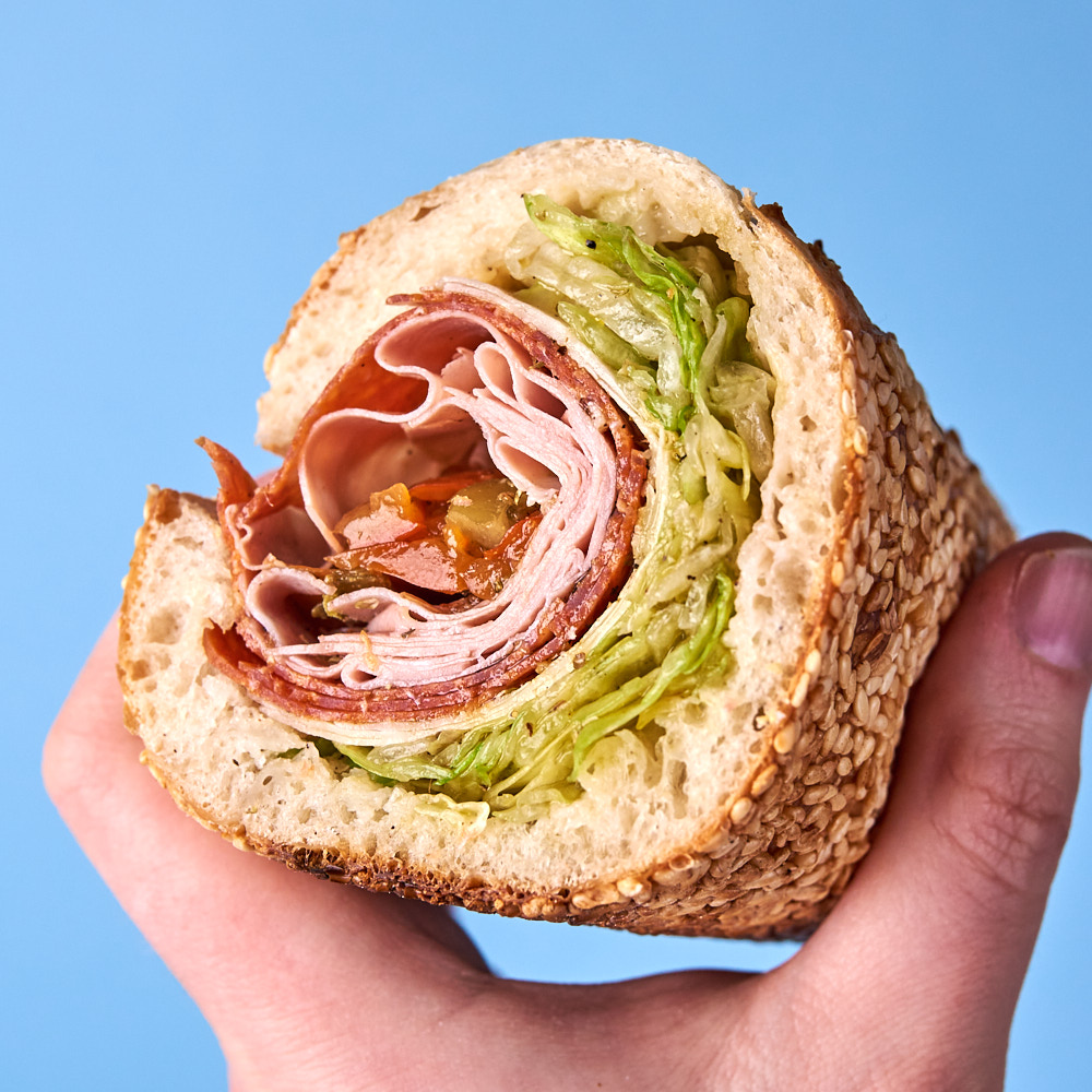 Iceberg lettuce, sharp provolone, pepperoni, mortadella, and chopped cherry peppers, dressed with red wine vinegar and salt and olive oil, black pepper, and oregano.