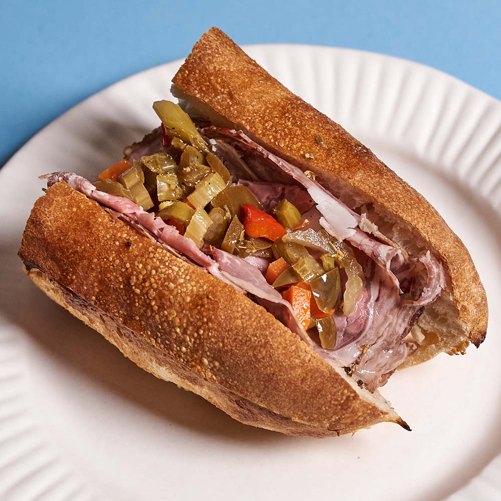 An Italian beef-inspired hoagie. Thinly-sliced dry-aged rib roast and giardiniera with a beef jus.
