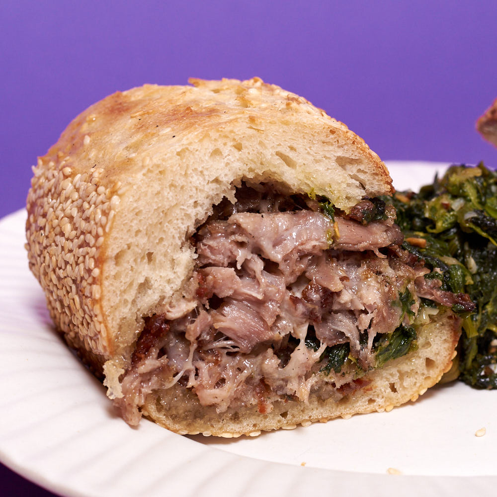 Pork confit, sharp provolone, and broccoli rabe on a seeded hoagie roll. Broccoli rabe is spilling out because I am a mess.