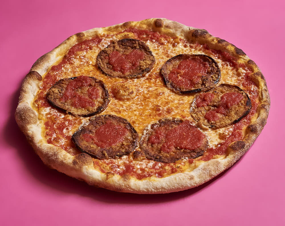 Pizza with aged mozzarella, tomato sauce, and fried eggplant. Baked in a typical home oven on a 3/8-inch-thick steel plate.