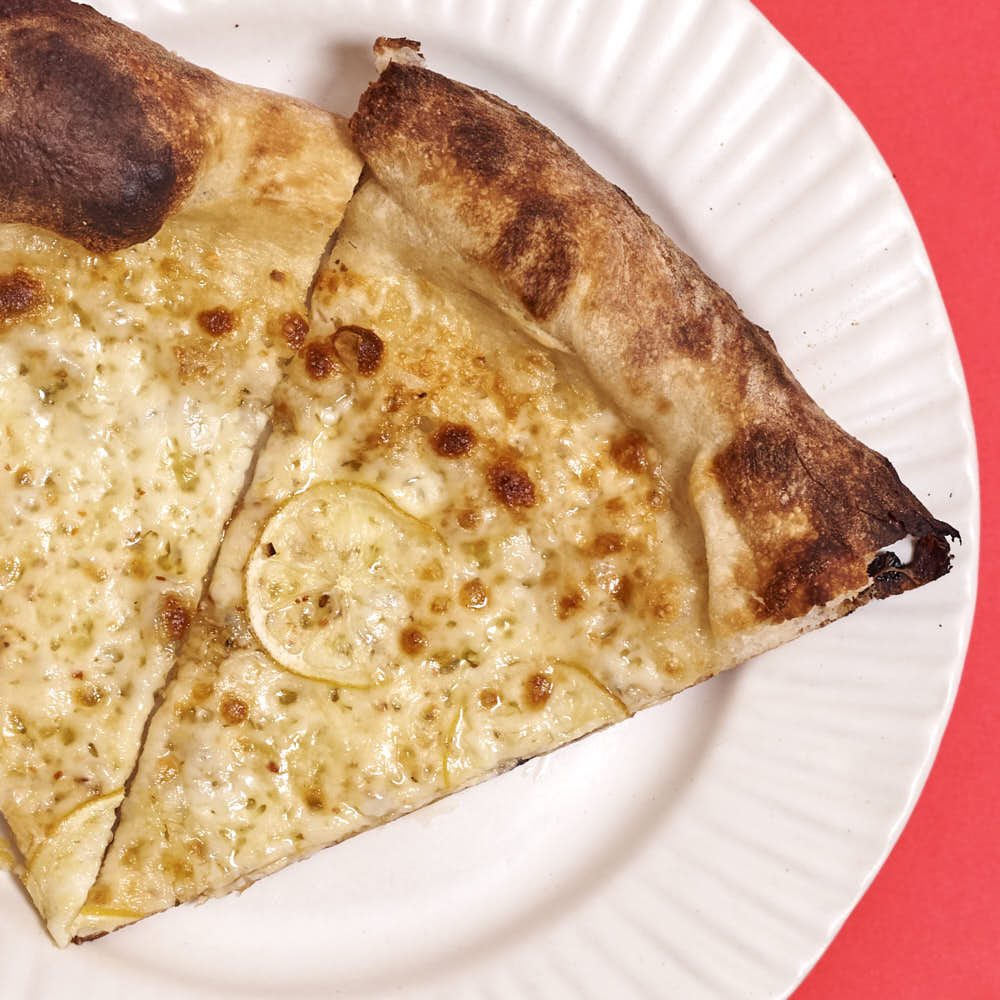 Pizza with aged mozzarella, and thinly sliced lemon. The acid from the lemon works well with the fat from the mozzarella. Baked in a typical home oven with 3/8-inch-thick steel plate.