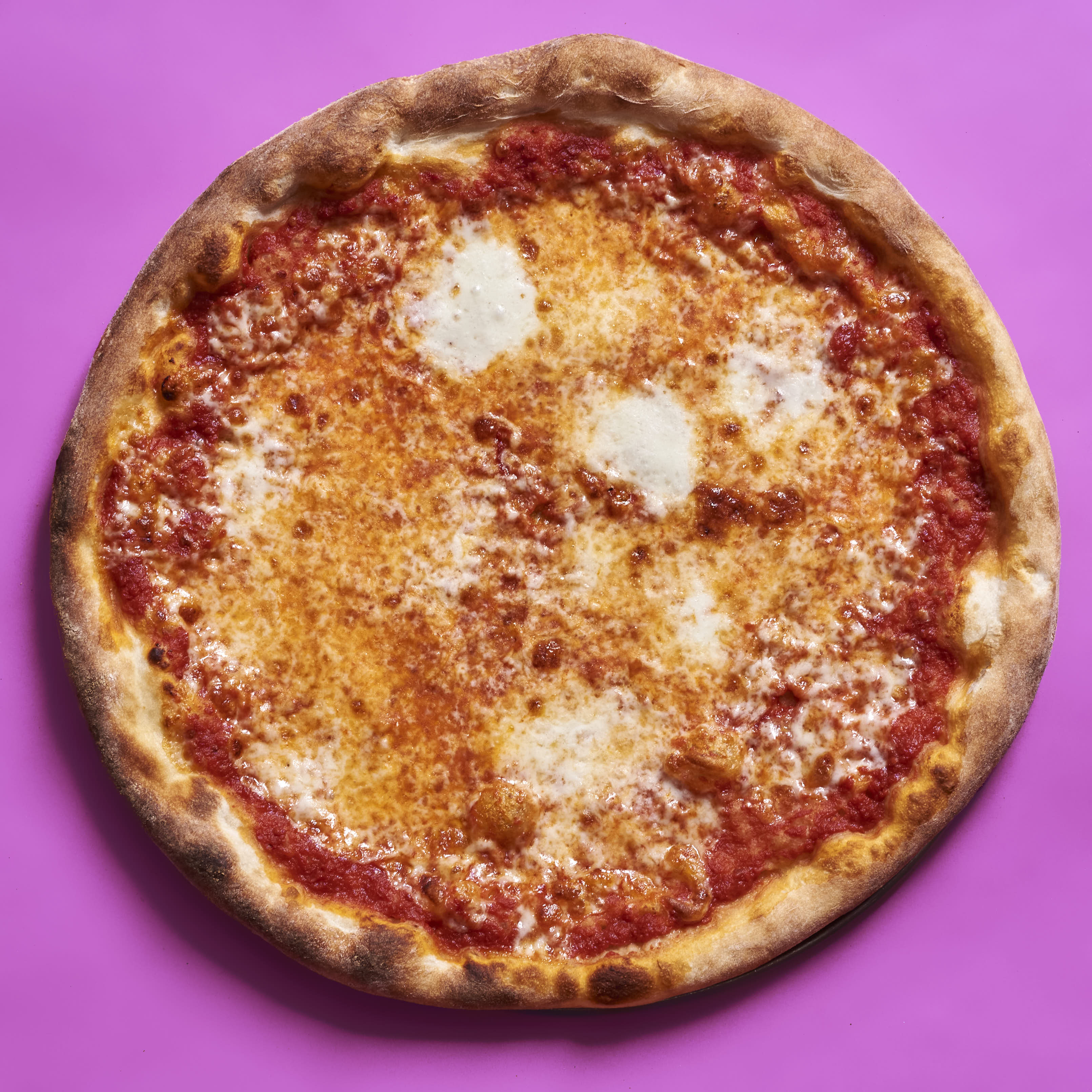 A pizza with tomato sauce, aged mozzarella, and fresh mozzarella. Baked in a typical home oven on a 3/8-inch-thick steel plate.