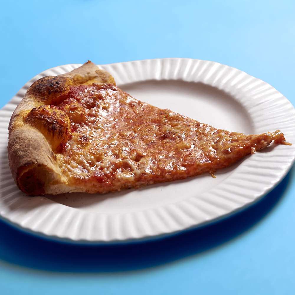 A pizza with aged mozzarella and tomato sauce. Baked in a typical home oven on a 3/8-inch-thick steel plate.