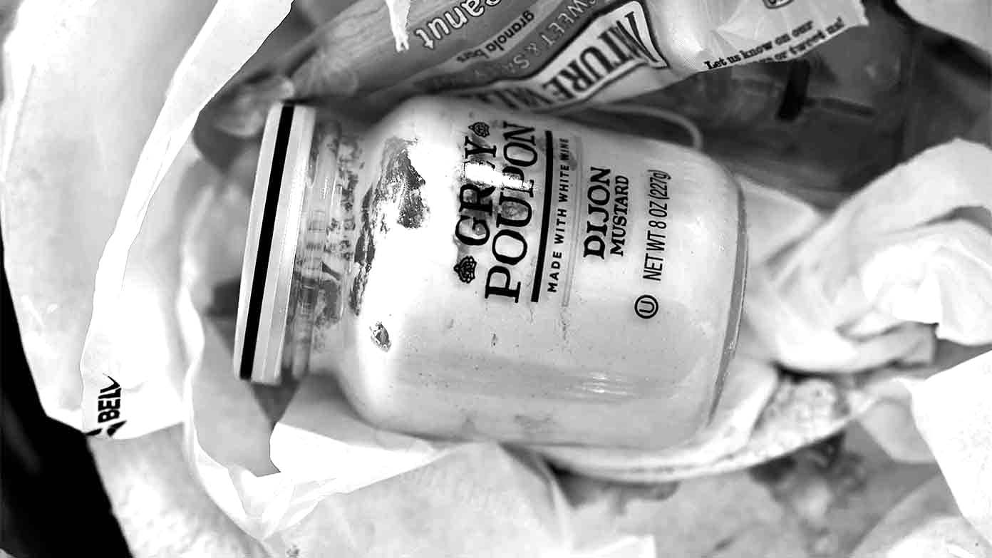 Grey Poupon in the trash.
